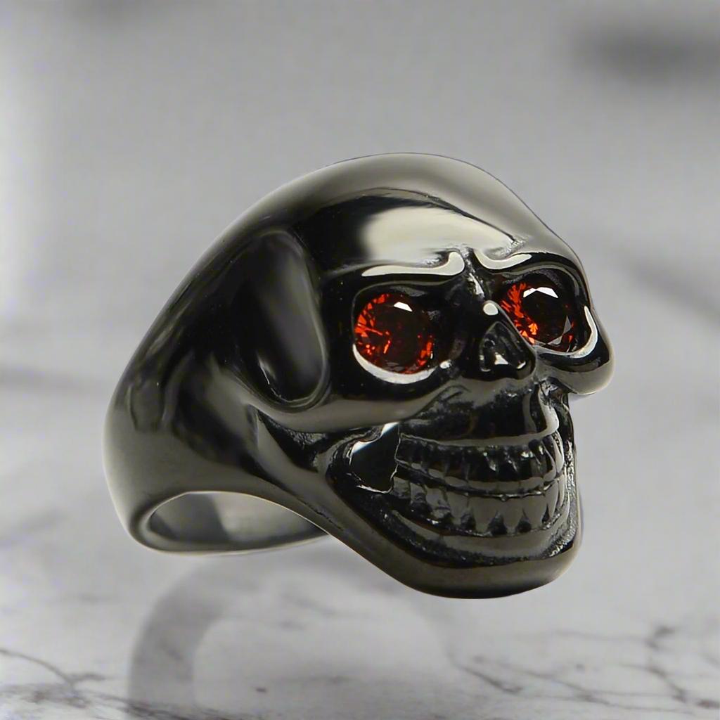 unisex black skull ring red gem eyes bold biker ring perfect gift for him or her durable high quality black plated fast free shipping stainless steel red cz eyed black skull ring top notch stainless steel enduring fiery red cubic zirconia eyes posh dark finish daring edgy vibe polished sterling silver silky smooth comfy to wear unique biker jewelry alternative fashion statement gothic punk rocker ring mens womens