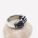 mens ring displayed on rock