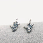 sterling silver skeleton skull hand stud earrings hypoallergenic fuck you flipping off funny sassy profanity high quality free shipping playful unique traditional jewelry intricate detailing edgy skull bones bold touch make a statement individuality hypoallergenic sterling silver high quality handmade punk gothic jewelry rebellious accessories alternative fashion statement earrings bold jewelry unique earrings sterling silver earrings sassy stud earrings bold statement jewelry