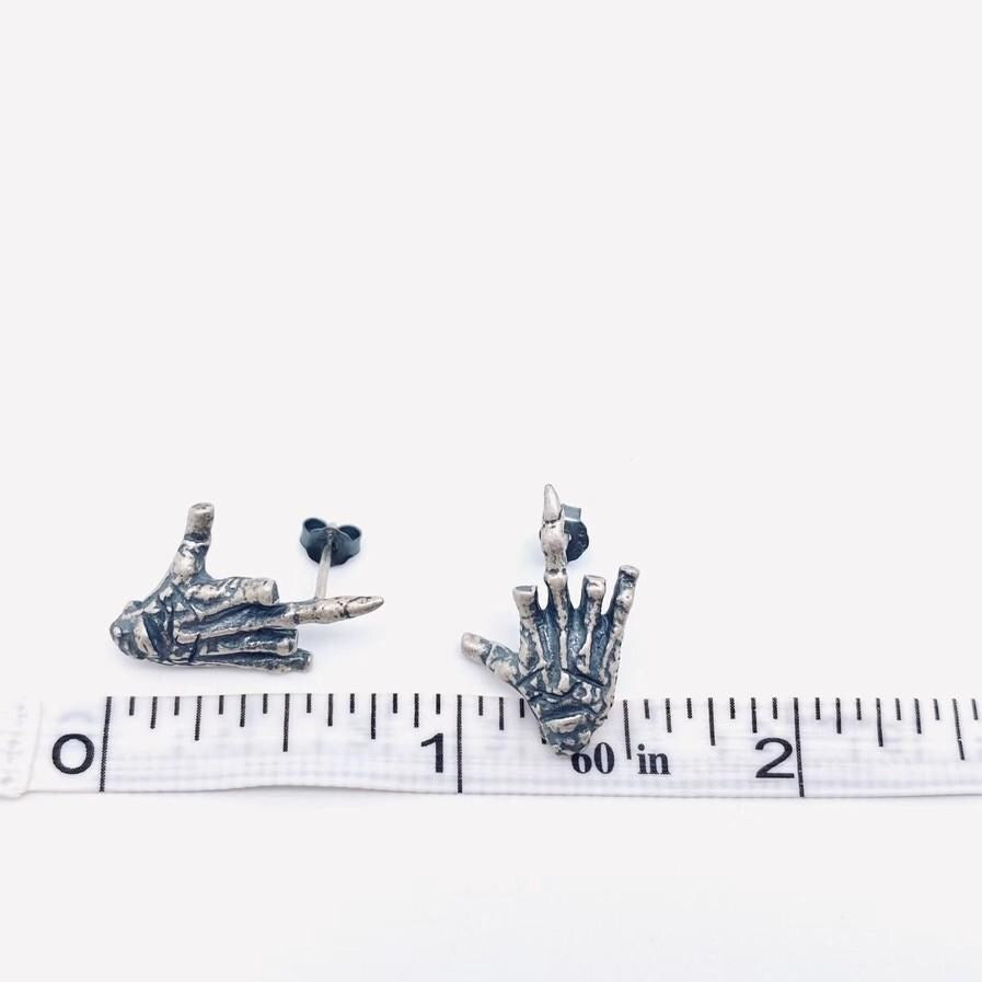 sterling silver skeleton skull hand stud earrings hypoallergenic fuck you flipping off funny sassy profanity high quality free shipping playful unique traditional jewelry intricate detailing edgy skull bones bold touch make a statement individuality hypoallergenic sterling silver high quality handmade punk gothic jewelry rebellious accessories alternative fashion statement earrings bold jewelry unique earrings sterling silver earrings sassy stud earrings bold statement jewelry
