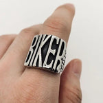 flip off middle finger ring stainless steel statement piece bold and enduring rebellious spirit rugged durability edgy style bikers motorcycle riders rock punk goth fashion big chunky ring eye-catching design substantial jewelry provocative touch unisex appeal versatile jewelry collection withstands test of time resilient and striking individuality strength leather jacket rock band t-shirt goth-inspired attire unique style concert open road everyday statement accessory handcrafted