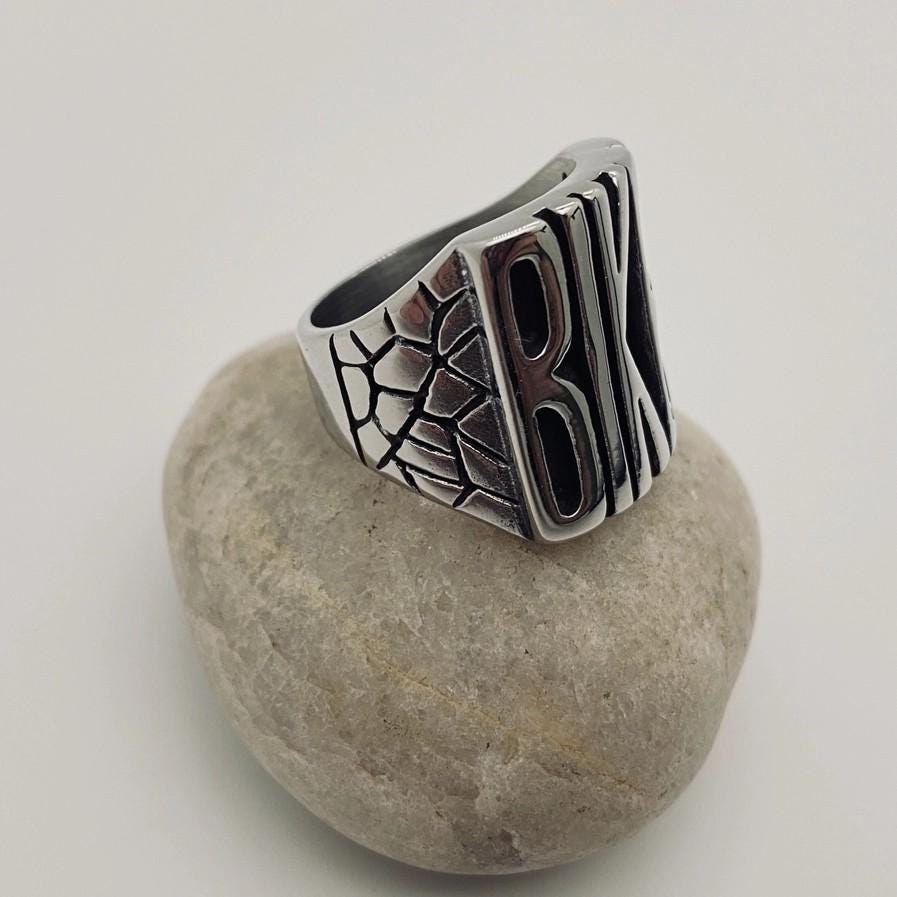 flip off middle finger ring stainless steel statement piece bold and enduring rebellious spirit rugged durability edgy style bikers motorcycle riders rock punk goth fashion big chunky ring eye-catching design substantial jewelry provocative touch unisex appeal versatile jewelry collection withstands test of time resilient and striking individuality strength leather jacket rock band t-shirt goth-inspired attire unique style concert open road everyday statement accessory handcrafted