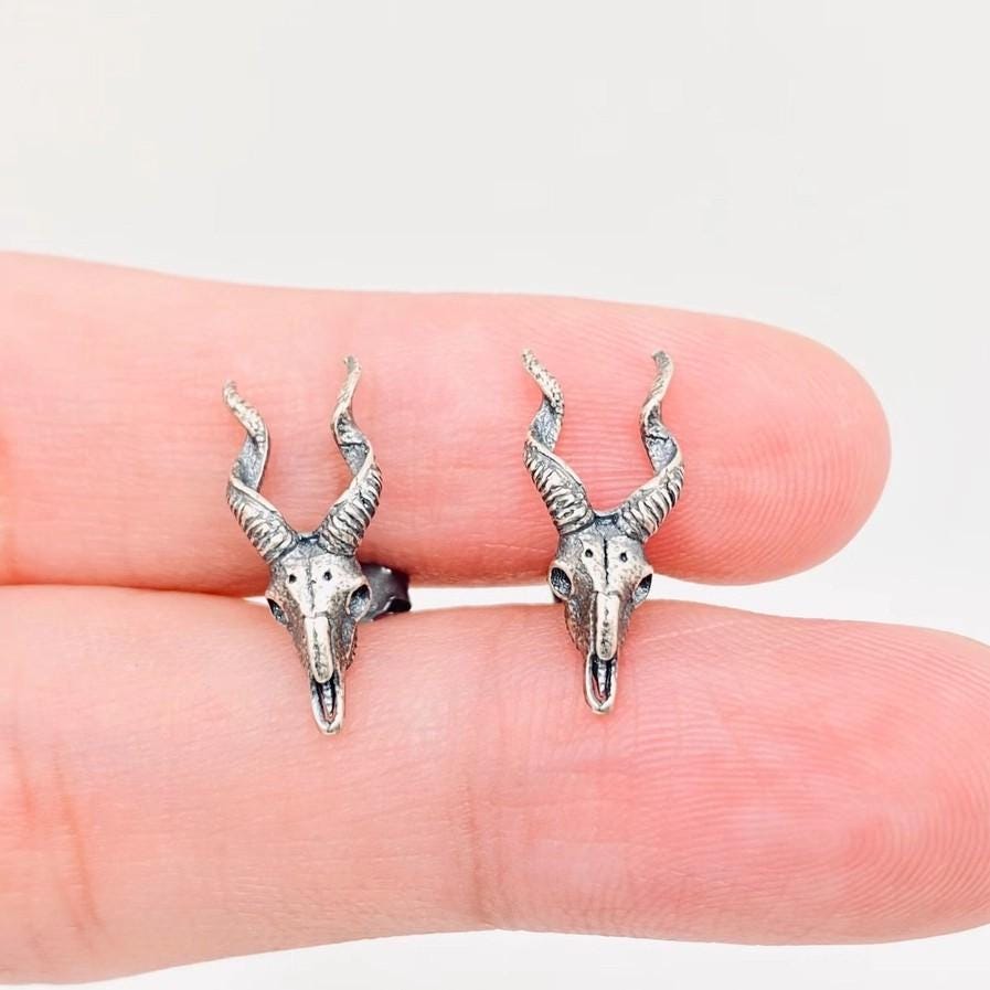 skull stud earrings, earrings for women, women biker jewelry, jewelry statement piece, piece gothic style, style silver accessory, accessory dark look, look bone structure, structure witch craft, craft halloween gift, gift alternative jewelry, jewelry punk design, design metal piece, piece gothic charm, charm skull stud, goat bone jewelry, jewelry statement earrings, earrings biker style, style dark accessory, accessory alternative design, design sterling silver,